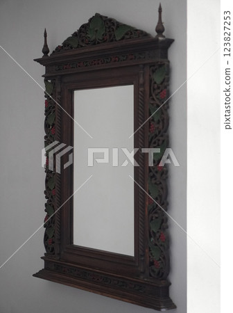 Mirror with wooden frame, mounted on a white cement wall on the side background, object, decor, decoration, copy space Mirror with wooden frame, mounted on a white cement wall on the side background, object, decor, decoration, copy space 123827253