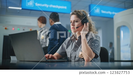 Airport Security Checkpoint: Female Security Officer Talking on Headset, Using Laptop Computer 123827753