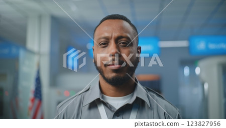 Airport Security Checkpoint: Portrait of Security Officer in Uniform Looking at Camera Airport Security Checkpoint: Portrait of Security Officer in Uniform Looking at Camera 123827956