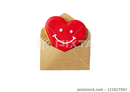 Red heart shape cookie in kraft envelope isolated on white background Red heart shape cookie in kraft envelope isolated on white background 123827983