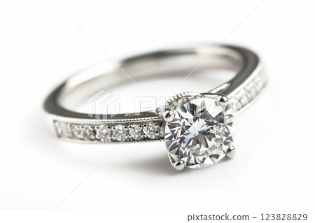 Closeup of a luxurious diamond ring showcasing a brilliant cut stone and pave setting on a seamless white backdrop 123828829