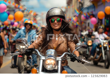 Joyful woman in stylish clothing and sunglasses rides her motorcycle among a vibrant parade, embracing the festive atmosphere 123829063