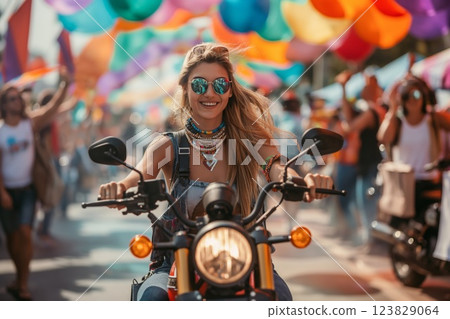 Radiant woman riding her motorcycle smiles brightly amidst a vibrant street festival with festive decorations and a joyful crowd 123829064