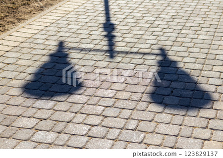 Shadow of the lamp post cast on the pavement Shadow of the lamp post cast on the pavement 123829137