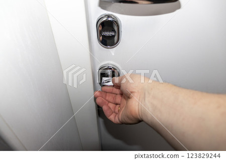 White door with metal handle and locks as a part of interior design White door with metal handle and locks as a part of interior design 123829244