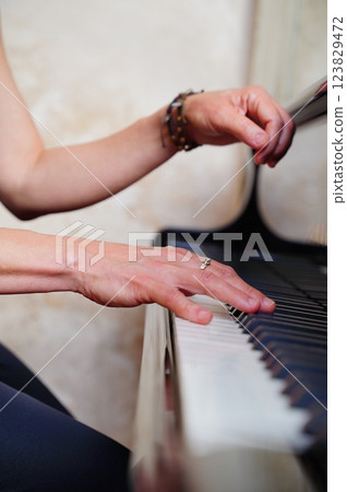 Hands of a pianist playing the piano 123829472