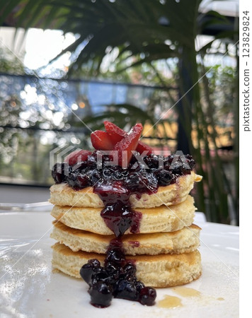 Delicious pancakes with berries, honey or maple syrup . Delicious pancakes with berries, honey or maple syrup . 123829824