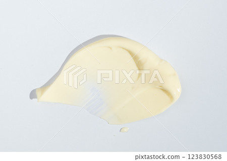 Close-up smear of mayonnaise sauce on white background, top view. 123830568