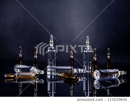 Ampoules with medicine on glossy black background 123830648