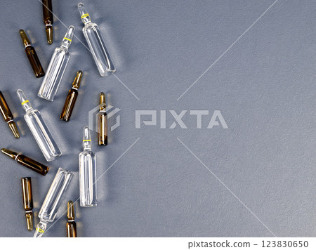 Ampoules with medicine on gray background Ampoules with medicine on gray background 123830650