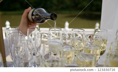 Sparkling wine pouring into elegant glasses montage 123830716