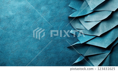 Abstract textured background with layered and crumpled blue paper on the right side, creating a dynamic composition with rough and smooth surfaces for creative design projects. 123831025