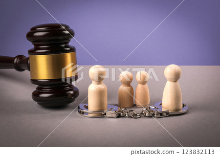 Wooden human figures on a gray table. Divorce and child custody dispute concept 123832113