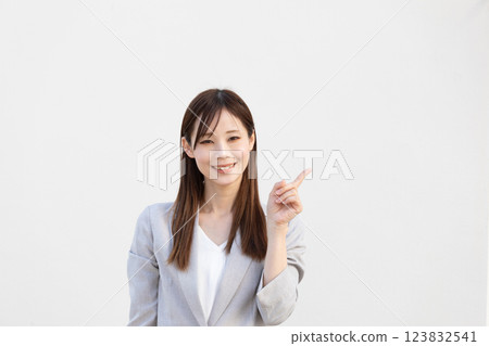 Image of a woman pointing at something (stock photo) 123832541