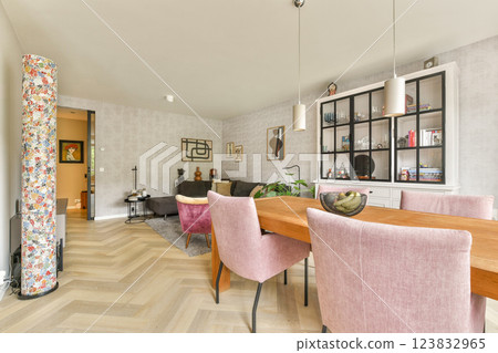 A stylish modern interior featuring an inviting living space with elegant furnishings, wooden flooring, and soothing color tones that create a cozy atmosphere. 123832965