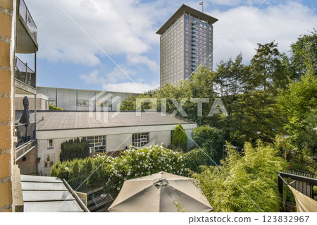 A vibrant urban scene showcasing a blend of modern architecture and lush greenery, highlighting the harmony between buildings and nature. 123832967