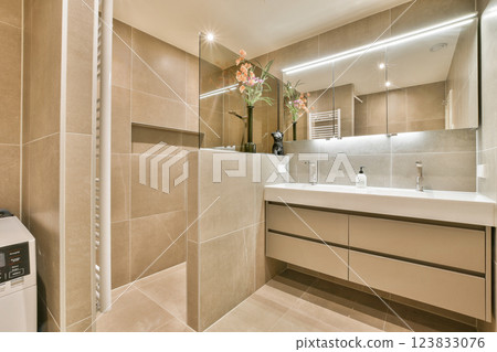 Sleek and stylish modern bathroom featuring minimalist design, elegant fixtures, and natural elements that enhance the overall atmosphere. 123833076