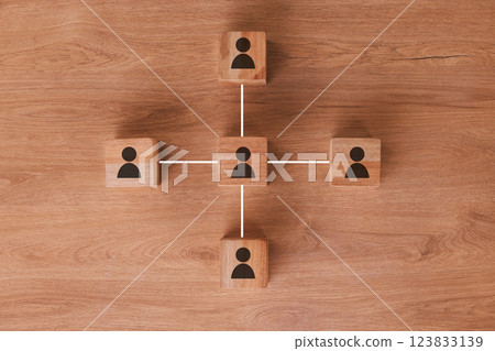 Wood, networking and communication with wooden blocks connected on a brown surface for collaboration or synergy. Marketing, teamwork and connectivity with block icons joined in partnership from above 123833139