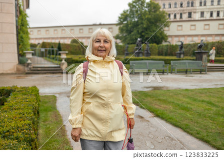 A female tourist walks around along a decorative alley decorated with many statues in a decorative park at Wallenstein Palace building in Prague in Czech Republic A female tourist walks around along a decorative alley decorated with many statues in a decorative park at Wallenstein Palace building in Prague in Czech Republic 123833225