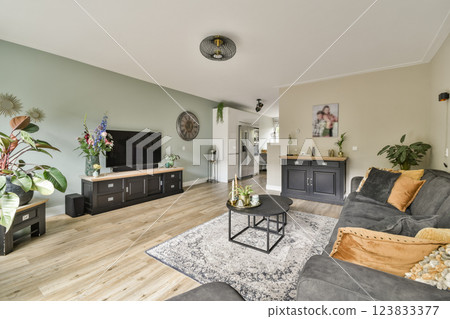 A stylish modern living room featuring contemporary furniture, a cozy atmosphere, and elegant decor elements, perfect for relaxation and socializing. A stylish modern living room featuring contemporary furniture, a cozy atmosphere, and elegant decor elements, perfect for relaxation and socializing. 123833377