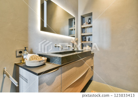 Stylish bathroom featuring sleek fixtures, natural tones, and contemporary storage solutions, perfect for modern living spaces. Stylish bathroom featuring sleek fixtures, natural tones, and contemporary storage solutions, perfect for modern living spaces. 123833413