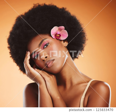 Black woman, beauty and makeup, skin and face with flower, hair and natural cosmetics advertising. African American model, skincare and cosmetology treatment, glow in portrait with studio background. 123833470
