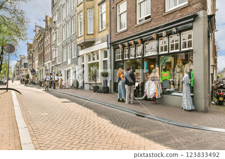 A picturesque street scene featuring an array of shops and people. The vibrant architecture adds a unique charm to this lively urban setting. A picturesque street scene featuring an array of shops and people. The vibrant architecture adds a unique charm to this lively urban setting. 123833492