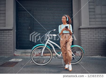 Phone, bike and city travel for woman with music headphones, podcast or radio in London city. Thinking fashion student, mobile or cool model with eco friendly and future environment energy transport 123833553