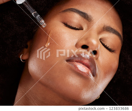 Face, skincare and black woman with pipette serum for healthy skin. Wellness, beauty and young model from Nigeria with hyaluronic oil dropper for flawless skin, moisturizing or facial treatment. Face, skincare and black woman with pipette serum for healthy skin. Wellness, beauty and young model from Nigeria with hyaluronic oil dropper for flawless skin, moisturizing or facial treatment. 123833686