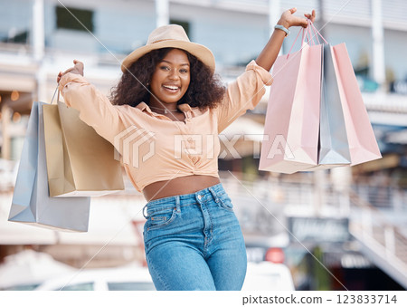 Shopping, fashion and retail, a black woman with a smile outside mall. Happy customer after discount sale at the shopping mall, city girl smiling with designer boutique bags and fun on summer holiday Shopping, fashion and retail, a black woman with a smile outside mall. Happy customer after discount sale at the shopping mall, city girl smiling with designer boutique bags and fun on summer holiday 123833714
