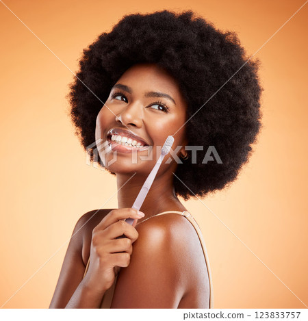 Toothbrush, dental and black woman with smile for teeth against a mockup orange studio background. Young, African and thinking model with wellness and health results from cleaning mouth with product Toothbrush, dental and black woman with smile for teeth against a mockup orange studio background. Young, African and thinking model with wellness and health results from cleaning mouth with product 123833757