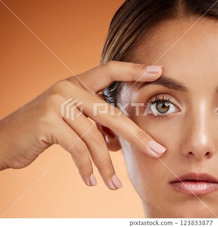 Vision, eye and beauty with face of woman for health awareness, awake and idea in orange background. Youth, cosmetics and inspiration with girl and zoom in stare for intense, serious or humanity 123833877