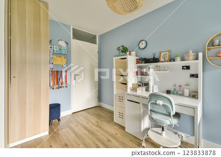A well-organized contemporary room featuring a desk, chairs, and decorative items, perfect for a stylish home office or study space. A well-organized contemporary room featuring a desk, chairs, and decorative items, perfect for a stylish home office or study space. 123833878