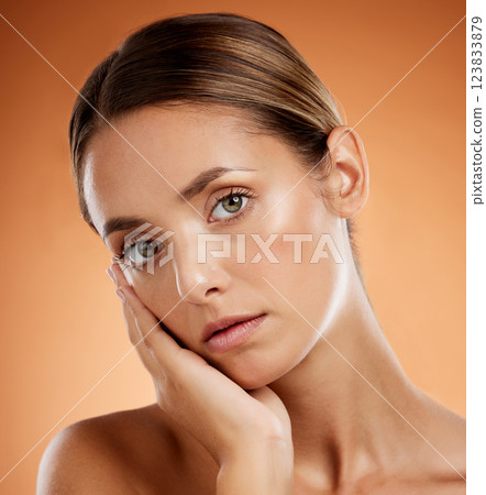 Skincare, portrait and woman with face makeup for beauty against an orange studio background. Young girl model with wellness from a spa, dermatology facial care and cosmetics for health of body Skincare, portrait and woman with face makeup for beauty against an orange studio background. Young girl model with wellness from a spa, dermatology facial care and cosmetics for health of body 123833879