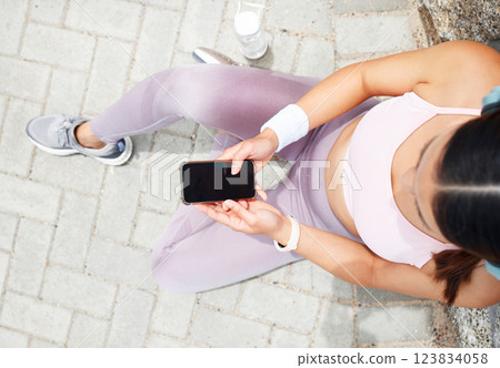 Smartphone screen, fitness mockup and woman check online app for exercise goal progress in city or park ground. Sports runner using phone for social media post, update or workout results outdoor Smartphone screen, fitness mockup and woman check online app for exercise goal progress in city or park ground. Sports runner using phone for social media post, update or workout results outdoor 123834058