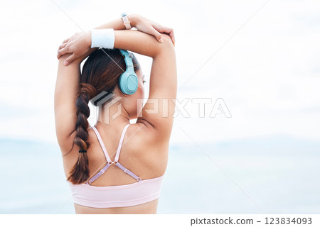 Fitness, sports and woman stretching with music on in warm up for training, cardio exercise and running workout. Tattoo, headphones and back view of girl athlete or runner ready to start challenge Fitness, sports and woman stretching with music on in warm up for training, cardio exercise and running workout. Tattoo, headphones and back view of girl athlete or runner ready to start challenge 123834093