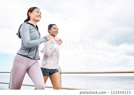 Friends, women and running by ocean, sea or promenade for wellness, fitness and health. Diversity, exercise and happy girls out for a run, cardio workout or training together outdoors by seashore. Friends, women and running by ocean, sea or promenade for wellness, fitness and health. Diversity, exercise and happy girls out for a run, cardio workout or training together outdoors by seashore. 123834115