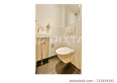 A sleek and contemporary bathroom featuring a wall-mounted sink and a streamlined toilet with tiles and polished flooring, emphasizing minimalist aesthetics. A sleek and contemporary bathroom featuring a wall-mounted sink and a streamlined toilet with tiles and polished flooring, emphasizing minimalist aesthetics. 123834161