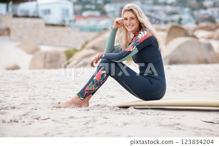 Happy woman, relax and surfer on beach sand for happiness, calm and peace on summer vacation or holiday travel. Young female, portrait in wetsuit and surfboard chill by ocean after surf training Happy woman, relax and surfer on beach sand for happiness, calm and peace on summer vacation or holiday travel. Young female, portrait in wetsuit and surfboard chill by ocean after surf training 123834204