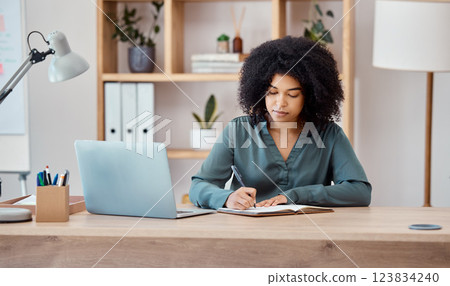 Laptop, black business woman writing in notebook or planning schedule or agenda for project management in office. Employee, manager or corporate worker with research for strategy innovation idea 123834240