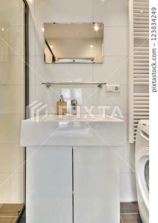 Stylish bathroom featuring a sleek vanity, contemporary fixtures, and a minimalistic aesthetic. The space emphasizes cleanliness and modern elegance. Stylish bathroom featuring a sleek vanity, contemporary fixtures, and a minimalistic aesthetic. The space emphasizes cleanliness and modern elegance. 123834249