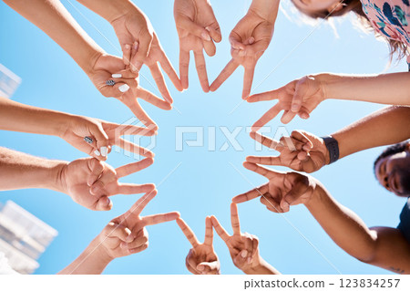 Friends, hands and star sign by volunteer group in support of environment cleaning project in summer blue sky from below. Peace, collaboration and teamwork by happy people gathering to help community 123834257