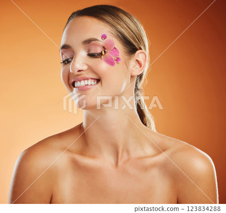 Flower, face and woman with smile for skincare against a brown mockup studio background. Thinking, happy and creative model with orchid plant for facial wellness, beauty and happiness in spring Flower, face and woman with smile for skincare against a brown mockup studio background. Thinking, happy and creative model with orchid plant for facial wellness, beauty and happiness in spring 123834288
