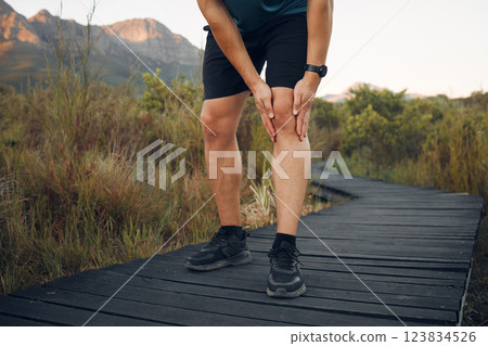 Knee pain, running and exercise in nature, man holding leg from sore joint or muscle. Training, fitness and runner exercising in woods or mountain trail with sports injury, athlete hurt after workout 123834526