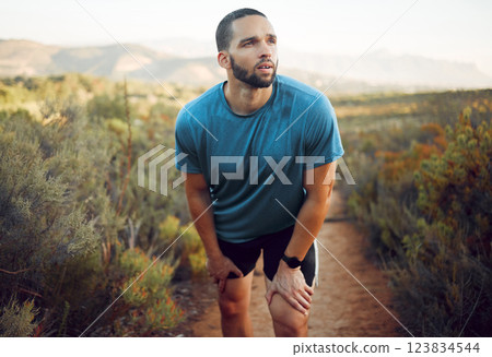 Tired runner, man running on nature park trail fitness training exercise and cardio health for a summer marathon. Sport athlete run workout, rest on natural road and train for sports race competition Tired runner, man running on nature park trail fitness training exercise and cardio health for a summer marathon. Sport athlete run workout, rest on natural road and train for sports race competition 123834544