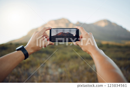 Hands, phone and mountain picture in nature for adventure, travel and countryside in the outdoors. Hand of traveler taking a photo of the natural environment with mobile smartphone in South Africa 123834561