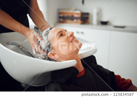 Shampoo, hairdresser and happy customer at a salon cleaning, massage and washing head for luxury wellness treatment. Hands, happiness and beauty client with a smile at a grooming makeover in New York Shampoo, hairdresser and happy customer at a salon cleaning, massage and washing head for luxury wellness treatment. Hands, happiness and beauty client with a smile at a grooming makeover in New York 123834587