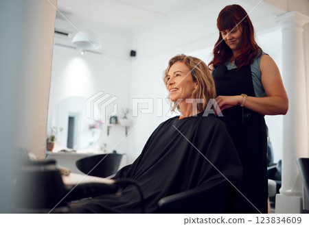 Beauty, hairdresser and happy customer at a salon for grooming, fancy and beautiful makeover. Smile, wellness and professional stylist working on an elegant senior client or mature woman in Canada 123834609