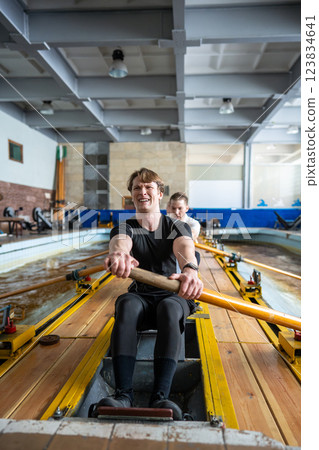 Dedicated male rowing crew practices synchronization, paddling preparing, sports activity and hobby 123834641