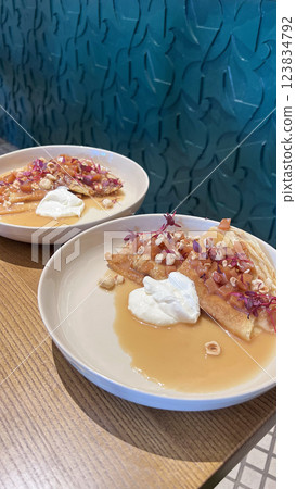 Breakfast in the restaurant. Pancakes with nuts. Spectacular presentation. 123834792